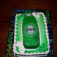 Hieneken Bottle Hieneken bottle on top of a qaurter sheet cake. With white roses. Everything was airbrushed.