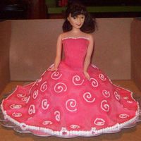 Pink Doll My First covered fondant cake. It is marble cake inside with a buttercream coat than covered in hot pink fondant. White buttercream swirls...