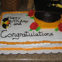 High School Graduation Cap sheet cake yellow with buttercream, hat is chocolate with ch. buttercream made with half of a ball mold, lid is cardboard cover with icing...