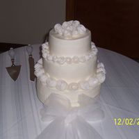 Retro Roses Wedding Cake This was my first wedding cake...roses are made from fondant...bottom 10 in is french Vanilla, middle 8 in is lemon, top 6 in is almond......