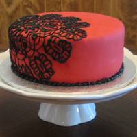 Black Lace 8" chocolate with chocolate buttercream covered in fondant. Detail was traced then piped.