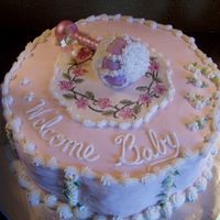 Welcome_Baby This is a 12" buttercream iced baby cake. The rattle was a carved cupcake with a gumpaste handle. The plaque was made of white...