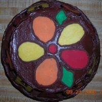 Top Of Cake closeup of 6" and 8" layer cake. chocolate tranfer flower, done in pieces and arranged on cake. second cake ever!!!