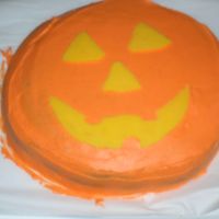 Pumpkin Cake chocolate cake with buttercream icing. The pumpkin face is made using a chocolate transfer
