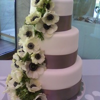 Luscious Lime 3 tier Key Lime cake with Key-Lime buttercream covered in homemade MMF. Fresh flowers.
