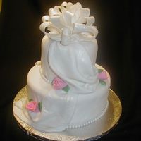 Classic Wedding 6" & 10" yellow cake with buttercream filling. Crumbcoated in buttercream and covered in fondant.
