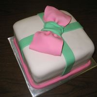 The Present Yellow cake with pineapple filling crumb coated in heavy buttercream and finished in fondant.