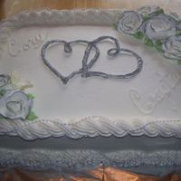 Bridal Shower Cake This is a double layer cake. The hearts are royal icing from the invitation. I brushed it with silver sparkle dust to make silver.