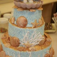 10Th Anniversary Cake For The Missouri State Fair 3 tier 10th Anniverary cake decorated for the Missouri State Fair. Chocolate shells, royal icing coral and used buttercream icing. It was a...