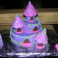 Purple Fantasy Castle For my daughters 6th birthday. Chocolate Fudge Cake, covered with MMF, buttercream accents & dragees. The MMF was drying out on me too...