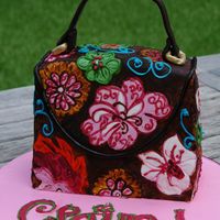 Vera Bradley Purse Cake Pattern on purse is copied from a Vera Bradley design. Cake covered in Fondant and painted.