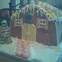 Gingerbread Cake She wanted a cake to look like a gingerbread house for a Christmas party. All fondant and candy decorations