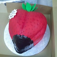 Strawberry carved from a couple of 11x15s covered with fondant. the seeds are black sesame seeds, and the chocolate is ganache