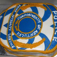 Owensboro Police Cake 1/2 sheet cake carved to resemble opd shoulder patch. Fondant and piped with buttercream