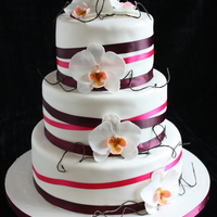Orchid Wedding Cake Fairly simple 6,8,10" rounds with fabric ribbons and my first gumpaste orchids. TFL