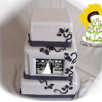 Photo Cake This is a 3 tier squared cake. Middle tier has a digital photo frame for picture display! Made with fondant and gunpaste.