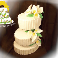 Calla Lily Cake This is a 3 tiered oval cake with pleats and calla lilies. Made with Fondant and Gumpaste!