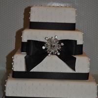 Dotty 4 Tier with dotted piping detail black ribbon bow finished with crystal brooch