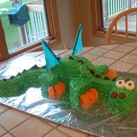 Bobby's Dragon Dragon cake, essentially made up of 3 - 9'' rounds, cut up and reassembled. Various candies and cookies used for decorations/...