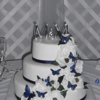 Monica 16/12/8 covered in fondant. Silk ribbon and gardenias with butterflies