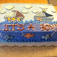 Sailboat Baby Shower This cake was made for a baby shower with a sailboat theme. The baby bedding was provided to me for ideas on how to decorate.