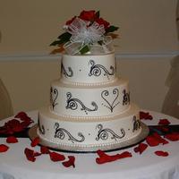 Wedding Cake- Blk & Wht Buttercream frosting with royal icing scroll work. The pearls are fondant.
