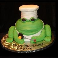 Frog Chef The body of the frog is buttercream, the arms and legs are RKT covered in fondant. The hat is a 4" cake topped with RKT and covered in...