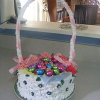Easter Basket This was a lemon cake with vanilla buttercream basketweave. Small flowers and leaves are RI. Pink carnations are made from starburst...