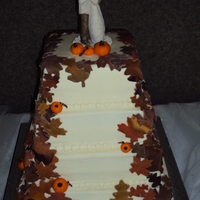 Fall Wedding Cake 4 tier fall wedding cake, leaves and pumpkins are mmf and cake is covered in buttercream.