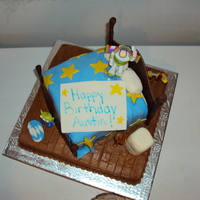 Toy Story Themed The bottom cake is covered with buttercream, The "bed" is covered with MMF, the accents are MMF as well.