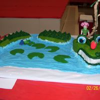 Gator Wants Strawberry The gator is frosted in buttercream. The eyes, nose,teeth, and spikes are rolled buttercream. Fairy , strawberry, and fish are gumpaste....