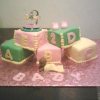 Baby Blocks Cake..tinker Bell Theme My first cake with blocks by themselves. 4 different flavor cakes covered in fondant..blanket on baby made with fondant also
