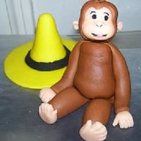 Curious George curious george and yellow hat made of fondant.