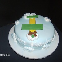 Airplane BUTTER CAKE,WITH VANILLA BC THEN COVERED IN FONDANT WITH MERINGUE COOOKIES FOR CLOUDS AND FONDANT PLANE WITH TOOTSIE ROLL PROPELARS