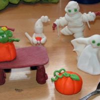 Halloween Figures Ghost, Mummie, Frankenstein out of pumpkin and Pumpkin from fondant/ gumpaste. Also made a table for putting little things on.The little...