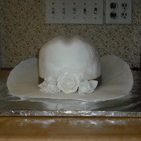 Western Wedding Made for my mothers wedding. Oval cakes staked and carved to shape. Covered in fondant with fondant roses. Brim fondant also. Learning...