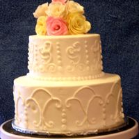 50Th Anniversary French Vanilla cake, torted with Strawberry cream. BC with gumpaste roses. This was my first attempt at scroll work.