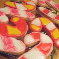 Candy Cane Cookies Basic sugar cookie decorated with royal icing and sanding sugar.