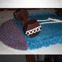 Skateboard Cake This is a yellow cake with BC frosting.I used a 9x13 and 2 9' round halves, and did a bit of carving to get the right shape.The trucks...