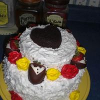 Tuxes And Roses chocolate cake with BC frosting, BC roses, and tuxedo strawberries. This was the first cake I made as a part of my senior project.Comments...