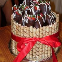 100_0578.jpg Chocoltae cake, buttercream frosting, chocolate ganache with pirouline coolies and chocolate dipped strawberries.