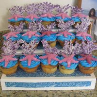 Ocean Cupcakes Marble cake with cream filling. The starfish is sugar molded and the coral is purple tinted white chocolate piped on wax paper and covered...