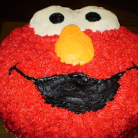 Elmo Birthday Cake Free-hand carving of Elmo's head, vanilla cake, vanilla buttercream. This was for a two-year old who loves the character!
