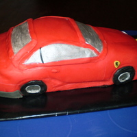 Ferrari 599 Gtb My first attempt carving a car from cake. It was hard and did not come out as I hoped, but my husband loved it (made for his birthday).