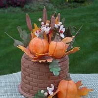 Gumpaste Fall Arrangement GP pumpkins, leaves, bittersweet, cattails. Basket is styrofoam, covered with GP