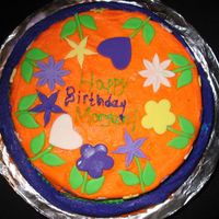 Purple And Orange Cake 2 layer chocolate cake, one 10" and one 8", frosted with violet and orange frosting. Decorated with fondant flowers.