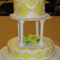 Final_Project_007.jpg 2 tiered cake with fondant decorations and flowers.