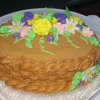 Flower Basket Oval cake with basket weave and royal icing flowers.