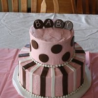 Annabelle Baby shower cake. White cake, strawberry buttercream. Fondant Accents. Cakes are 10" and 6".
