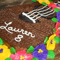 Lauren_Cake1.jpg My daughter had a luau themed party. I made a ukelele cake and used marshmallow fondant to create a "lei" draped on top.